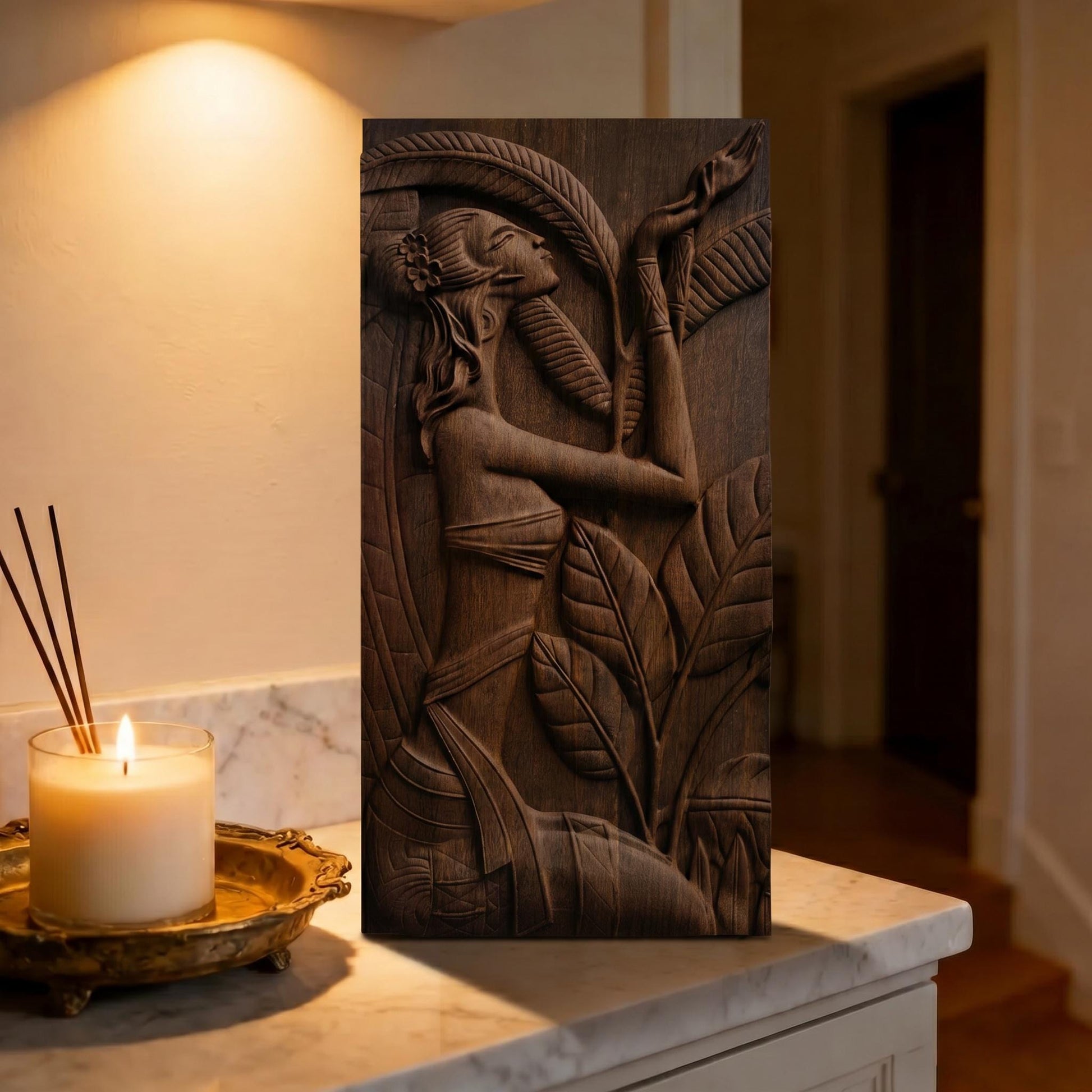 May include: A dark brown wooden relief carving of a woman amidst large leaves. The woman is depicted with her arms raised, and the carving is detailed with intricate lines. The artwork is rectangular and stands upright.